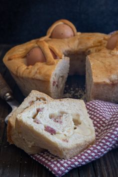 a piece of bread that has been cut in half and is sitting on top of a checkered cloth