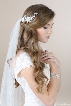 a woman in a wedding dress with a veil on her head