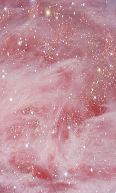 an image of pink and gold glitters in the sky with stars on it's surface