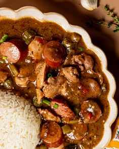 a white plate topped with rice and meat