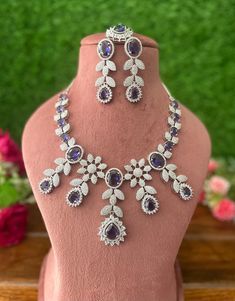 Gorgeous fine quality lavender purple CZ lab diamonds studded necklace set in White gold plating and matching Earrings, maangtika *Comes with Statement matching earrings and maangtika  *AAA quality cubic zirconia used. *Highest quality and craftsmanship Necklace Fitting is adjustable with an adjustable metal chain  Necklace length 15 inches (adjustable length) Each earring weighs 15 gms Earrings length 2.4 inches  Earrings Closure: Pushback Item is ready to be shipped from New Delhi, India  IMPO Purple Diamond Necklaces For Wedding, Purple Diamond Necklace For Wedding, Purple Diamond Wedding Necklace, Dazzling Purple Jewelry With Diamond Accents, Dazzling Purple Wedding Jewelry, Purple Cubic Zirconia Necklaces For Party, Purple Cubic Zirconia Jewelry With Sparkling Stones, Purple Crystal Jewelry Sets For Formal Occasions, Formal Purple Jewelry With Sparkling Stones