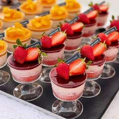 small desserts with strawberries are arranged on a tray