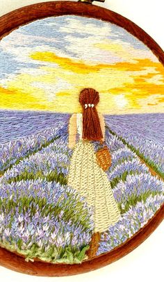 a woman standing in a field of flowers with a bird on her shoulder