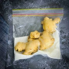 three pieces of bread sitting on top of a piece of wax paper in a bag