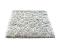 a white area rug that has been made out of fur and is on the floor