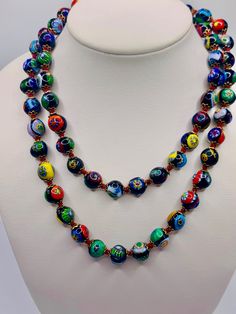 - Vintage Venetian millefiori glass beaded necklace  - 30 inch necklace  - Hand knotted  - Gold tone costume metal accents around each bead  - Well made  - Clean and in good condition  K 3234 Adjustable Murano Glass Necklaces With Round Beads, Adjustable Murano Glass Necklace With Round Beads, Adjustable Murano Glass Round Beads Necklace, Murano Glass Polished Bead Necklaces, Murano Glass Beaded Necklace With Polished Beads, Adjustable Beaded Necklace With Large Murano Glass Beads, Round Polished Murano Glass Beaded Necklace, Glass Bead Necklaces 8mm, Glass Bead Necklaces With 8mm Round Beads