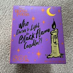 a purple book with a lit candle on it