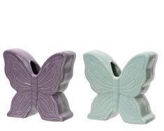 two ceramic butterfly toothbrush holders on a white background