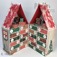 an open book with christmas decorations on the front and sides, sitting next to each other