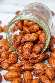 a jar filled with almonds sitting on top of a table