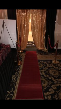 a red carpeted aisle leading to an entrance