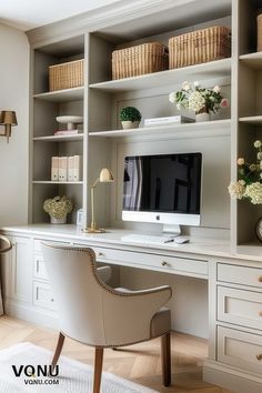 Elegant home office setup with built-in shelves, a sleek desk, and a comfortable chair in neutral tones, featuring wicker baskets and fresh flowers. Office Snug Room, White Masculine Office, Traditional Modern Office Decor, Built In Desk With File Cabinets, Styling Office Desk, Office Interior Design Built In, Office Fitted Furniture, Taupe Office Built Ins, Awkward Office Layout