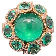 newly arrived and an absolute exceptional piece, an emerald ring in outstanding colored stone and brilliant quality, in outstanding goldsmith work in 18 kt yellow gold, similar hardly to find, a star brazilian emerald cabochon of more than 35 ct (20.4 x 19.6 x 12.0 mm), surrounded by 8 oval faceted columbian emeralds of approx. 10 ct (7.3 to 8.0 x 5.9 to 7.0 mm), all emeralds in top quality AAA+ with hardly any inclusions and finest color quality, in drop-shaped settings, in halo style surrounde Gem Rings Stones 1stdibs, Vintage Cluster Ring, Pearl Cluster Ring, Emerald Cabochon, Chrome Tourmaline, Columbian Emeralds, Cartier Panthere, Emerald Diamond Ring, Bracelet Love