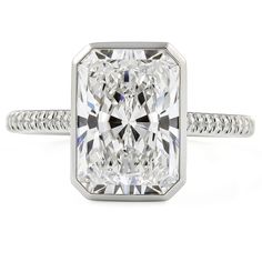 a cushion cut diamond ring set in 18k white gold