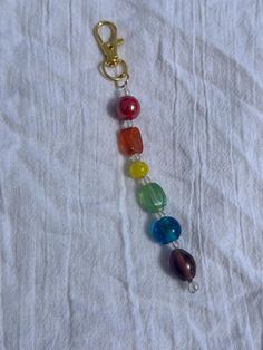 a multi colored beaded keychain on a white sheet