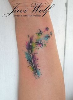 a woman's arm with a feather tattoo on it