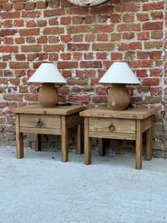 two wooden tables sitting next to each other in front of a brick wall with a clock on it