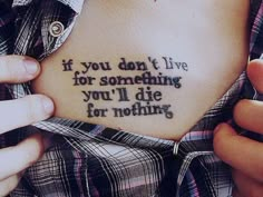 someone holding their stomach with the words if you don't live for something you'll die for nothing on it