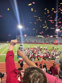 a football game with confetti thrown in the air