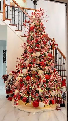 a christmas tree decorated with candy canes and candies is on display in the foyer