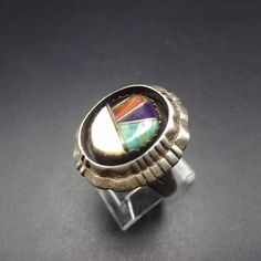 "VINTAGE NAVAJO RING DESCRIPTION: This exclusive ring features perfect channel inlay of blue-green turquoise, red coral, black jet, and mother of pearl. The inlay is secure in a chisel-stamped, shadowbox setting. This ring will be a treasured addition to your collection of fine vintage Native American jewelry. MEASUREMENTS: Ring face measures 7/8\" x 3/4\" RING SIZE: 9 WEIGHT: 9.8 grams SIGNED: no STERLING: yes, stamped STERLING" Multicolor Inlay Rings For Anniversary, Unique Multicolor Rings With Polished Finish, Multicolor Oval Inlay Rings, Oval Multicolor Rings With Inlay, Anniversary Multicolor Inlay Rings, Southwestern Multicolor Inlay Rings, Southwestern Style Multicolor Inlay Rings, Jewelry Measurements, Turquoise Men