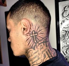 a man with a cross tattoo on his neck