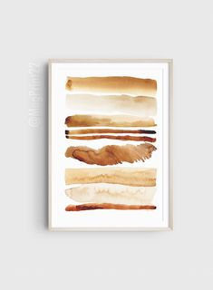 an abstract watercolor painting with brown and tan colors on it, framed in a white frame