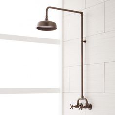 the shower head is mounted on the wall next to the bathtub faucet