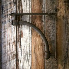 an old metal handle on a wooden door