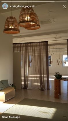 a living room filled with furniture and hanging lights