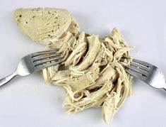 a fork and some food on a white table