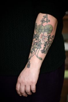 a person with a flower tattoo on their arm