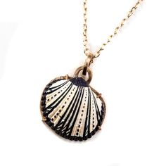 We have collected shells from our world travels for over 40 years. We are now turning these found treasures into jewelry. Each shell is mounted in a unique hand-made nautical bronze setting.  Each necklace is one of a kind, skillfully hand-painted with an individual design.  The finished pendant is mounted on a 20 inch gold chain with a custom hand-made hook clasp.  2Roses has been making art jewelry for over five decades. Our jewelry is sold in over 42 countries and has been exhibited in many museums around the world including the V&A London, Hermitage St Petersburg, LACMA, NY Museum of Art & Design, and the Menghi San Diego to name a few. The studio is recognized for its innovative use of unusual materials to create unique objects of adornment.  These painted shell necklaces are both ele Coastal Style Shell Shaped Jewelry For Gifts, Shell Necklace For Jewelry Making, Artisan Shell Jewelry For The Beach, Coastal Style Shell Jewelry, Nautical Style Gold Jewelry For The Beach, Vintage Shell Necklaces For The Beach, Vintage Shell Necklace As Gift, Vintage Shell Necklaces For Beach, Vintage Pendant Necklace For Beach