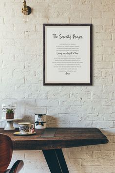 there is a framed print on the wall above a table with coffee cups and mugs