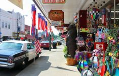 an american flag and other patriotic items are on display at the storefront for sale