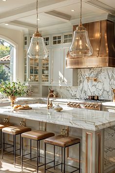 a kitchen with marble counter tops and stools in front of an island that has three hanging lights over it