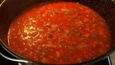 a pot filled with soup sitting on top of a stove