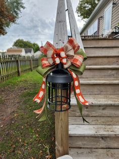 a lantern with a bow on it sitting in front of some steps