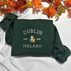 Stay warm and look stylish with this unique Dublin Ireland embroidered  at the center of the chest This piece of clothing is perfect for any casual occasion. The high-quality fabric keeps you warm and comfortable, while the intricate embroidery brings a touch of elegance and charm to any ensemble. Whether you're out and about or just lounging at home, this sweatshirt is sure to make you stand out from the crowd. The sweatshirt also features a classic crew neckline and long sleeves for a timeless look. It's available in a range of sizes and colors, so you're sure to find the perfect one to suit your style. Plus, it's easy to care for, making it the perfect addition to your wardrobe. Product Benefits: * Stylish and fashionable  * Comfortable and warm * Unique embroidered pattern * Classic cr Green Sweatshirt With Embroidered Logo For Fall, Green Sweater With Embroidered Logo For Fall, Fall Green Sweater With Embroidered Logo, Green Embroidered Logo Sweater For Fall, Green Fall Sweater With Embroidered Logo, Green Long Sleeve T-shirt With Custom Embroidery, Fall College T-shirt With Embroidered Logo, Casual Embroidered Logo T-shirt For Fall, Long Sleeve T-shirt With Embroidered Logo For Fall