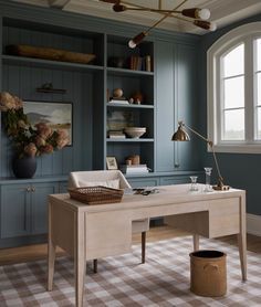 a room with blue cabinets and a checkered rug on the floor in front of it