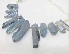 "I LOVE these LUSTER FINISH IRREGULAR GRADUATED SPIKES--I am not sure if they are glass or stone with a coating. They look like natural stone, but the finish is not quite like anything I have seen before. The color is a soft blue to blue-gray, and while each piece LOOKS rough and irregular, the finish is very smooth and glassy and shimmery. The beaded section of this necklace is a fan of these beads about 7\" wide. The shortest pieces are about 1\" long and the longest about 2\" long. It has a v Adjustable Blue Jewelry With Raw Stone, Adjustable Blue Raw Stone Jewelry, Adjustable Raw Blue Stone Jewelry, Adjustable Silver Necklace With Mineral Crystal, Useable Gifts, Star Wars Theme Party, Tote Outfit, Farmers Market Bag, Spike Necklace