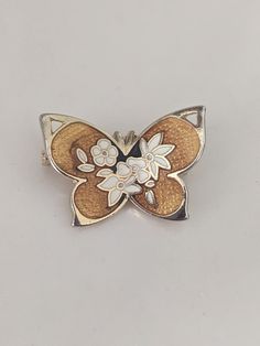 Lovely vintage gold tone butterfly pin with enameled flowers.  Item is shown as is. Vintage Gold Butterfly Ring Gift, Butterfly Enamel Pin, Collectible Gold Flower Enamel Pin, Elegant Butterfly Shaped Pins, Gold Butterfly-shaped Metal Jewelry, Butterfly-shaped Enamel Pin Gift, Vintage Gold Enamel Lapel Pin, Vintage Brass Butterflies, Gold Butterfly Brooches For Collectors