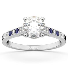 a diamond and blue sapphire engagement ring with channeled accents on the band, set in 18k white gold