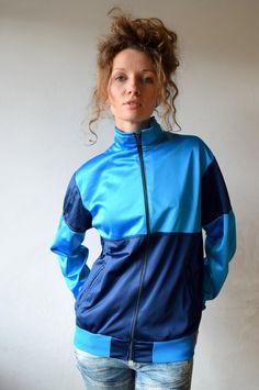 Blue workout jacket, Vintage jacket, Color block running jacket, Men outdoor jacket, Sport outerwear,Outdoor sportswear,Blue windbreaker,S/M Blue vintage sport jacket made in Finland. It has two side pockets with zipper closure and turtle neck what will protect you if it's windy outside. Dark and light blue color blocks will make your look more interesting and workouts or any activities more fun! Size: seems like women (M) and men (S) PLEASE CHECK ALL MEASUREMENTS BELLOW: Length: 63 cm/ 25" Shou Affordable Blue Nylon Windbreaker, Cheap Vintage Blue Windbreaker, Windproof Sportswear Windbreaker For Gym, Sporty Nylon Tracksuit For Sports, Athleisure Windproof Windbreaker For Gym, Athleisure Windproof Gym Windbreaker, Technical Moisture-wicking Windbreaker For Training, Winter Long Sleeve Training Tracksuit, Blue Winter Tracksuit For Streetwear