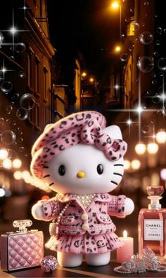 a hello kitty doll is standing next to some perfume bottles and candles in the dark