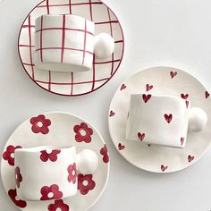 two plates with hearts on them, one has a cup and saucer