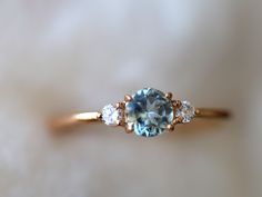 an aqua and white diamond three stone ring