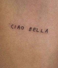 the word ciao bella written in cursive font on someone's lower back