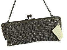 Lovely purse encrusted with hundreds of sparkling clear Swarovski crystals with great craftsmanship and there are no missing crystals.  Measurements are 7"8  wide, 3"3 high, 1/2 deep with a 44"5 shoulder strap with a 21" drop. On the interior there is one main compartment lined in fabric with a small back pocket, top kiss lock closure and the shoulder strap can be tucked inside and used as a clutch. I don't know if purse is new, but it looks in excellent condition and comes with original tags.  If you need additional pictures please let me know.  Contact If you have zero, excessive or hidden feedback please email me. Items are sold as is and if you have an questions please let me know before you purchase item.  Shipping Shipping is done with USPS priority mail within the U.S. and shipping Sparkling Rectangular Evening Bag, Sparkling Rectangular Evening Bags, Silver Rectangular Clutch For Cocktail, Silver Rectangular Evening Bag For Cocktail, Sparkling Clutch Evening Bag For Formal Occasions, Rectangular Silver Evening Bag For Cocktail, Silver Evening Bag With Rhinestones For Cocktail, Designer Rhinestone Evening Bag For Formal Occasions, Silver Rhinestone Evening Bag For Cocktail