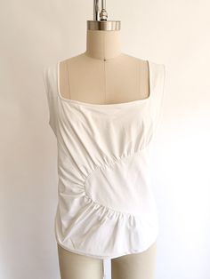 Gorp core stretchy Lycra tank top in frosty white with abstract pleated design front. Fabric: PolyesterLabel: Anne FontaineFit: L/XL (5)Era: 2000's Measurements: Bust 36" Shoulder 14.5" Length 22" Waist 31" Condition: Excellent White Sleeveless Ruched Top, White Ruched Sleeveless Top, White Ruched Tank Top For Summer, White Fitted Sleeveless Tank Top, White Fitted Sleeveless Top, Tank Tops, Fabric